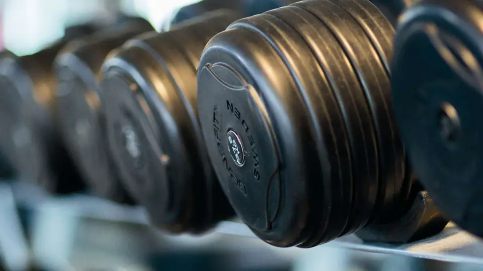 Round dumbbells on a rack, photographed close up