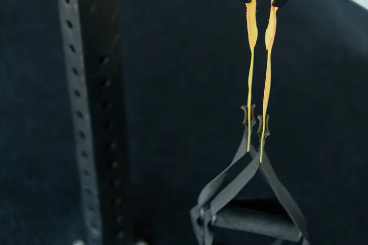 Suspension trainer straps hanging from a rack